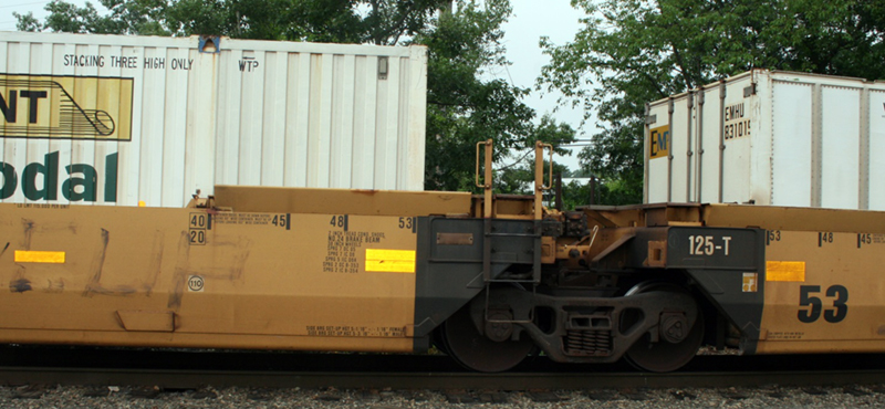 FIGURE 7. Well Car (also known as Double-Stack Car)
This image shows a low-floor well car carrying a full-sized container.
FIGURE 7. Well Car (also known as Double-Stack Car)
This image shows a low-floor well car carrying a full-sized container.